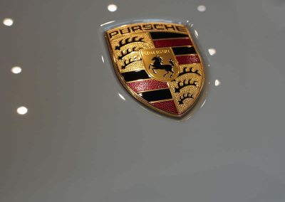 Porsche logo on hood of car